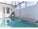 A refreshing pool with a waterfall feature in a private courtyard at 8768 Conch Ave, Placida, FL 33946