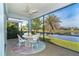 Screened porch with lake view and outdoor seating at 8768 Conch Ave, Placida, FL 33946