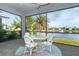 Enjoy water views from this screened porch with seating area at 8768 Conch Ave, Placida, FL 33946