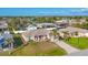 An aerial view of a single Gathering home showing the manicured lawn, two-car garage, and mature landscaping at 9240 New Martinsville Ave, Englewood, FL 34224