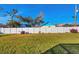 Fenced backyard with lush green grass and landscaping for privacy at 9240 New Martinsville Ave, Englewood, FL 34224