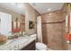 This bathroom features a granite counter, a sink, and a tiled shower at 9240 New Martinsville Ave, Englewood, FL 34224