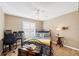 This bedroom features tile floors, a ceiling fan, and a desk at 9240 New Martinsville Ave, Englewood, FL 34224