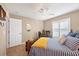 Bright bedroom featuring a ceiling fan, work desk, and tiled flooring at 9240 New Martinsville Ave, Englewood, FL 34224