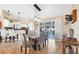 Dining room with modern chandelier and seating for six, next to a bright sliding glass door at 9240 New Martinsville Ave, Englewood, FL 34224