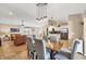 Open-concept dining area featuring a table for six, modern lighting, and easy access to the kitchen at 9240 New Martinsville Ave, Englewood, FL 34224