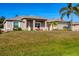 Charming single-story home featuring a manicured lawn, neutral exterior paint, and a two-car garage at 9240 New Martinsville Ave, Englewood, FL 34224