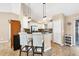 Modern kitchen featuring a breakfast bar, white cabinets, stainless steel appliances and tiled floor at 9240 New Martinsville Ave, Englewood, FL 34224