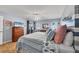 This main bedroom features tile flooring, a ceiling fan, and a sliding glass door to the home's exterior at 9240 New Martinsville Ave, Englewood, FL 34224