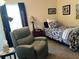 Cozy bedroom with a recliner, double bed, and plenty of natural light at 9458 Melody Circle, Port Charlotte, FL 33981