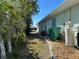 Side of house with AC unit and trash cans at 9458 Melody Circle, Port Charlotte, FL 33981