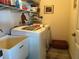 Convenient laundry room with washer, dryer, and extra shelving at 9458 Melody Circle, Port Charlotte, FL 33981