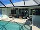 Inviting pool area with covered patio and fire pit at 9458 Melody Circle, Port Charlotte, FL 33981