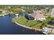 An aerial view of the property featuring a private dock and screened-in lanai at 9676 Singer Cir, Port Charlotte, FL 33981