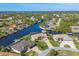 Stunning aerial view of the property with waterfront access, lush landscaping, and a serene canal setting at 9676 Singer Cir, Port Charlotte, FL 33981