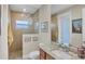 Modern bathroom features a glass-enclosed shower, granite countertops, and stylish fixtures at 9676 Singer Cir, Port Charlotte, FL 33981