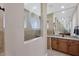 Bathroom showcases tiled walls, a granite countertop, tile flooring, and a unique glass shower partition at 9676 Singer Cir, Port Charlotte, FL 33981