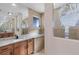 Bathroom with a large mirror, granite countertop, tile flooring, and a uniquely designed window at 9676 Singer Cir, Port Charlotte, FL 33981