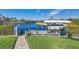 A boat is parked at a private dock with a boat lift and fenced-in yard at 9676 Singer Cir, Port Charlotte, FL 33981