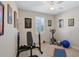 Home exercise room featuring tile flooring, lots of natural light, and a ceiling fan at 9676 Singer Cir, Port Charlotte, FL 33981