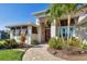 Inviting front entrance featuring a stone walkway, lush landscaping, and a striking red front door at 9676 Singer Cir, Port Charlotte, FL 33981