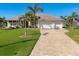 Beautiful home featuring manicured lawn, a spacious driveway and a three-car garage at 9676 Singer Cir, Port Charlotte, FL 33981