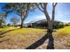 Spacious backyard with large trees, providing shade and privacy at 10 Sportsman Pl, Rotonda West, FL 33947