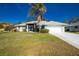 Front view of charming house with well-manicured lawn and driveway at 10 Sportsman Pl, Rotonda West, FL 33947