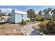 Backyard featuring a small storage shed surrounded by a landscaped path and mature trees at 1005 E 2Nd St, Englewood, FL 34223