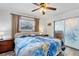 Cozy bedroom with wood-look floors, a ceiling fan, and natural lighting from the window at 1005 E 2Nd St, Englewood, FL 34223