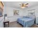 Simple bedroom with wood-look floors, neutral paint and natural light from the window at 1005 E 2Nd St, Englewood, FL 34223