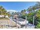 This beautiful canal features a dock and a boat parked in the water on a sunny day at 1005 E 2Nd St, Englewood, FL 34223