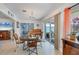Cozy dining room with sliding glass doors, a piano, and view of the outdoor space at 1005 E 2Nd St, Englewood, FL 34223