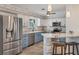 Updated kitchen with stainless steel appliances, granite countertops, stylish cabinets, and a breakfast bar at 1005 E 2Nd St, Englewood, FL 34223