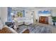 Bright living room with large windows, comfortable furniture, and tile flooring throughout at 1005 E 2Nd St, Englewood, FL 34223