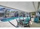 Outdoor patio with poolside seating and a grill, perfect for entertaining Gathering and friends at 1005 E 2Nd St, Englewood, FL 34223