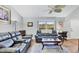 Cozy living room with plush seating, ceiling fan, and a large window showcasing the outdoors at 11167 Pendleton Ave, Englewood, FL 34224