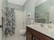 Clean bathroom with a tub shower and updated vanity at 11249 Mc Dermott Ct, Englewood, FL 34223