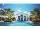 Community pool and clubhouse with seating at 11249 Mc Dermott Ct, Englewood, FL 34223