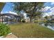 A lovely backyard with a screened-in pool overlooking a beautiful pond at 1216 Whitney Dr, Venice, FL 34293