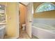 Bright bathroom with tile flooring and a bathtub with a window at 1216 Whitney Dr, Venice, FL 34293