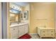 Bathroom featuring a vanity with white cabinetry, a mirror, and neutral walls at 1216 Whitney Dr, Venice, FL 34293