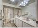 Bathroom featuring a double sink vanity, decorative fixtures, and a shower with floral curtain at 1216 Whitney Dr, Venice, FL 34293