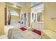 Bright bathroom with tile flooring, a bathtub, walk-in shower, and a vanity with ample storage at 1216 Whitney Dr, Venice, FL 34293