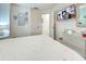 Bedroom featuring a bed with a white quilt and a TV on the wall at 1216 Whitney Dr, Venice, FL 34293