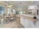 Breakfast nook with a ceiling fan, large windows, and view of the living room at 1216 Whitney Dr, Venice, FL 34293