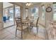 Bright breakfast nook featuring a stained-glass window, ceiling fan, and sliding glass doors to the patio at 1216 Whitney Dr, Venice, FL 34293