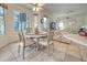 Breakfast nook with a stained-glass window, ceiling fan, and views of the backyard at 1216 Whitney Dr, Venice, FL 34293
