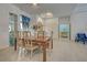 Bright dining room boasts a decorative chandelier, tile flooring, and elegant furniture at 1216 Whitney Dr, Venice, FL 34293