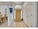 Warm foyer with neutral tile and a view into the adjacent dining room at 1216 Whitney Dr, Venice, FL 34293